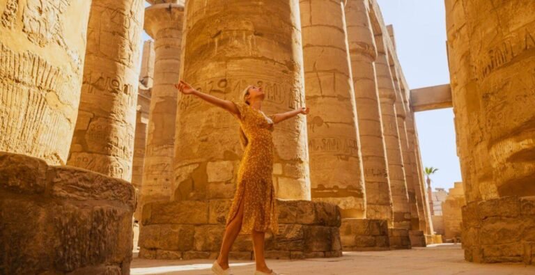 Woman enjoying her visit to Karnak Temple in Luxor, surrounded by ancient architecture and history.