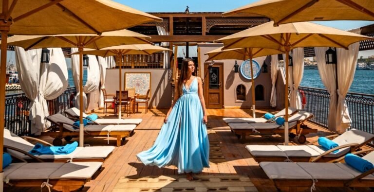 beautiful-woman-enjoying-the-stunning-views-of-egypts-landmarks-on-a-nile-cruise Beautiful woman enjoying stunning views of Egypt's landmarks during a Nile cruise.