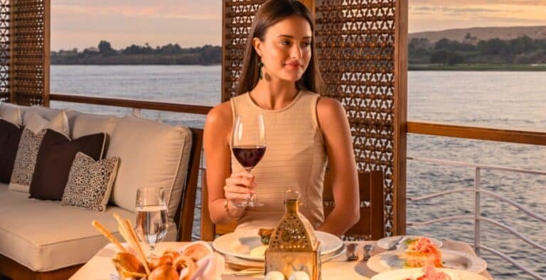 a-wonderful-lady-tries-delicious-egyptian-food-on-a-wonderful-nile-cruise A woman enjoying delicious Egyptian food while on a scenic Nile cruise.