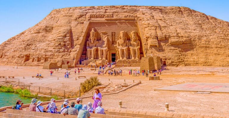 abu-simbel-temple-from-the-outside-with-a-large-group-of-tourists-standing-in-front-of-it Abu Simbel Temple exterior with a large group of tourists in front, showcasing its impressive architecture.