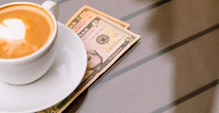 tips-and-coffee-on-table A cozy table with a cup of coffee and a notebook filled with tips.