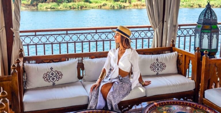 A beautiful woman enjoys her cruise on the Nile, surrounded by stunning landscapes.