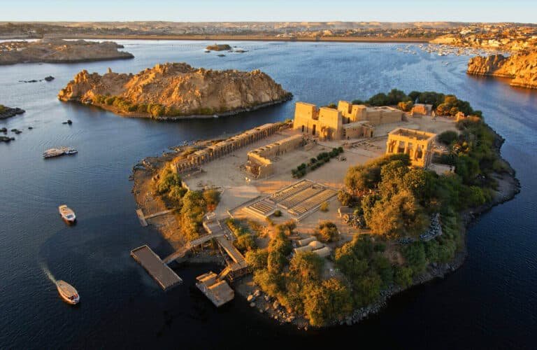 A stunning aerial view of Philae Temple on an island, showcasing its architecture and surrounding waters.