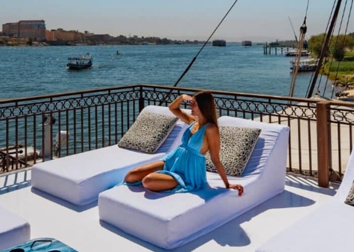 Tourist relaxing on a luxury Nile River cruise deck enjoying the ultimate travel experience.