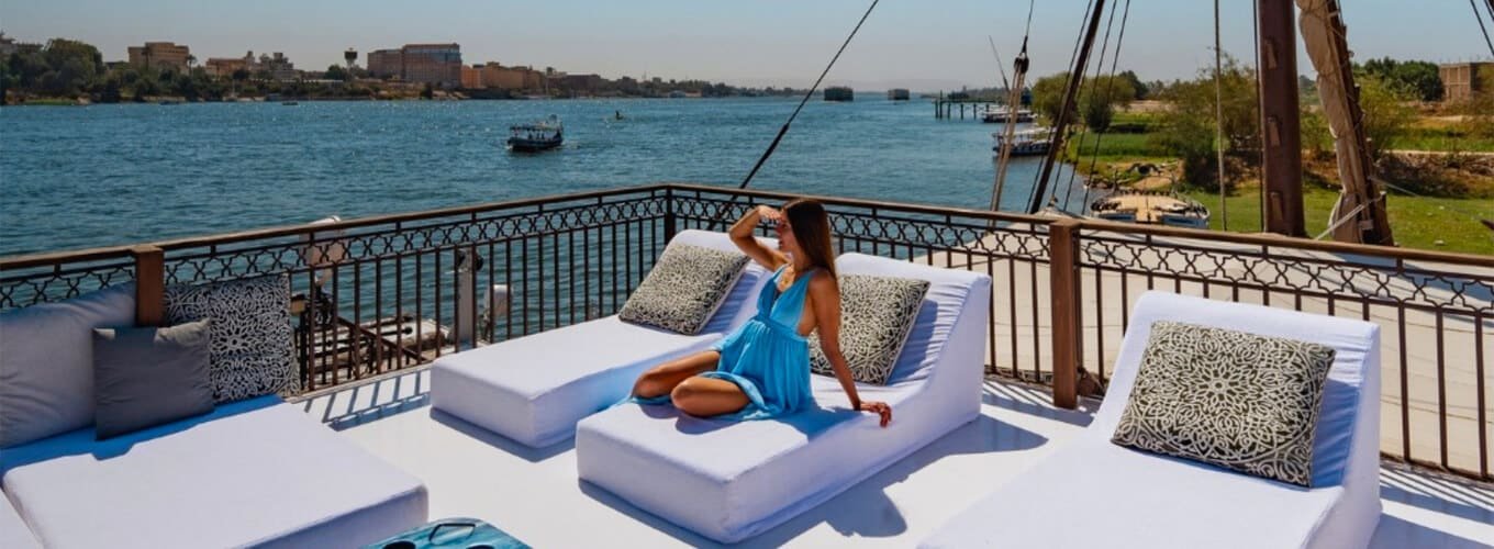Tourist relaxing on a luxury Nile River cruise deck enjoying the ultimate travel experience.