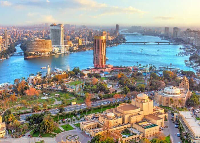 Panoramic aerial view of Cairo, Egypt skyline and Nile River at sunset