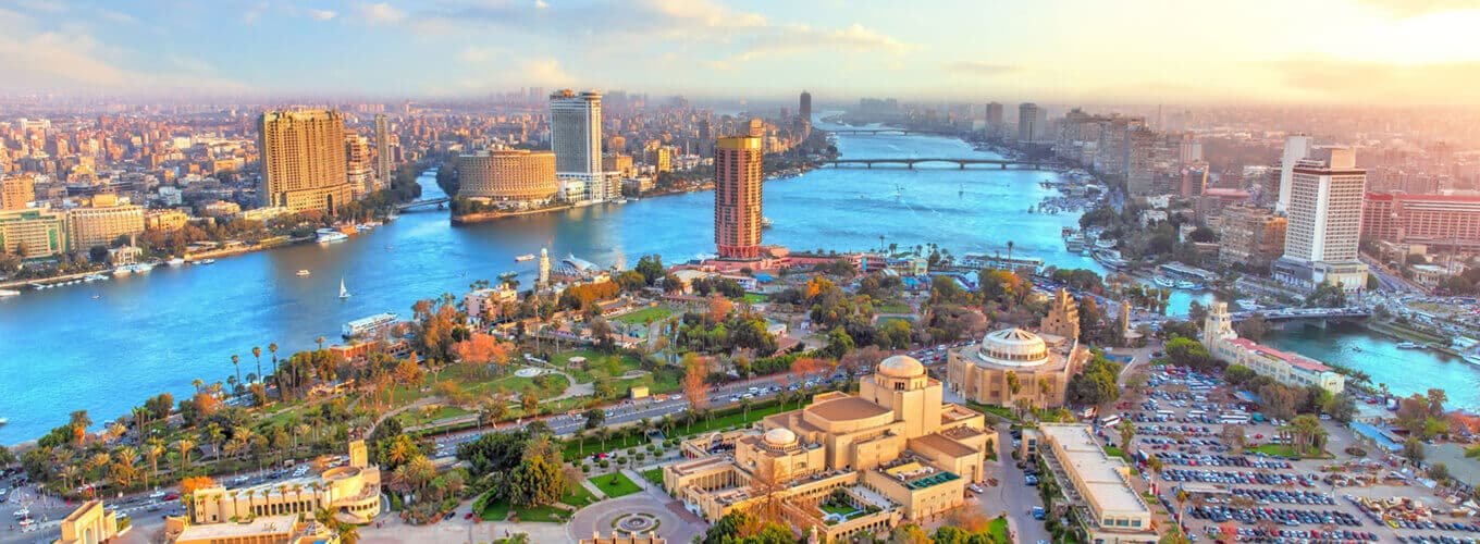 Panoramic aerial view of Cairo, Egypt skyline and Nile River at sunset