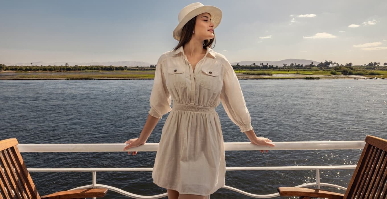 Woman in sun hat and dress on deck of Egypt cruise ship